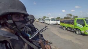 In this image made from video, Rwandan police patrol a road in Palma, Cabo Delgado province, Mozambique, Sunday Aug. 15, 2021. A new offensive by Mozambique’s Islamic extremist rebels in Cabo Delgado has increased the number of displaced by 80,000 and undermines the government’s claims of containing the insurgency. (AP Photo/Marc Hoogsteyns)