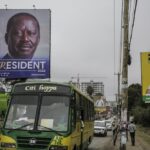 A bus drives past banners for Kenyan presidential candidates Raila Odinga, left, and William Ruto, right, on a road in the Mathare low-income neighborhood of Nairobi, Kenya Monday, Aug. 1, 2022. Kenya’s Aug. 9 election is ripping open the scars of inequality and corruption as East Africa’s economic hub chooses a successor to President Uhuru Kenyatta. (AP Photo/Brian Inganga)