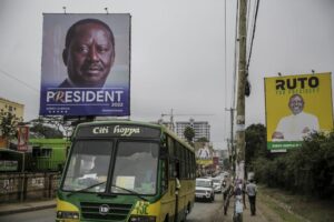 A bus drives past banners for Kenyan presidential candidates Raila Odinga, left, and William Ruto, right, on a road in the Mathare low-income neighborhood of Nairobi, Kenya Monday, Aug. 1, 2022. Kenya’s Aug. 9 election is ripping open the scars of inequality and corruption as East Africa’s economic hub chooses a successor to President Uhuru Kenyatta. (AP Photo/Brian Inganga)