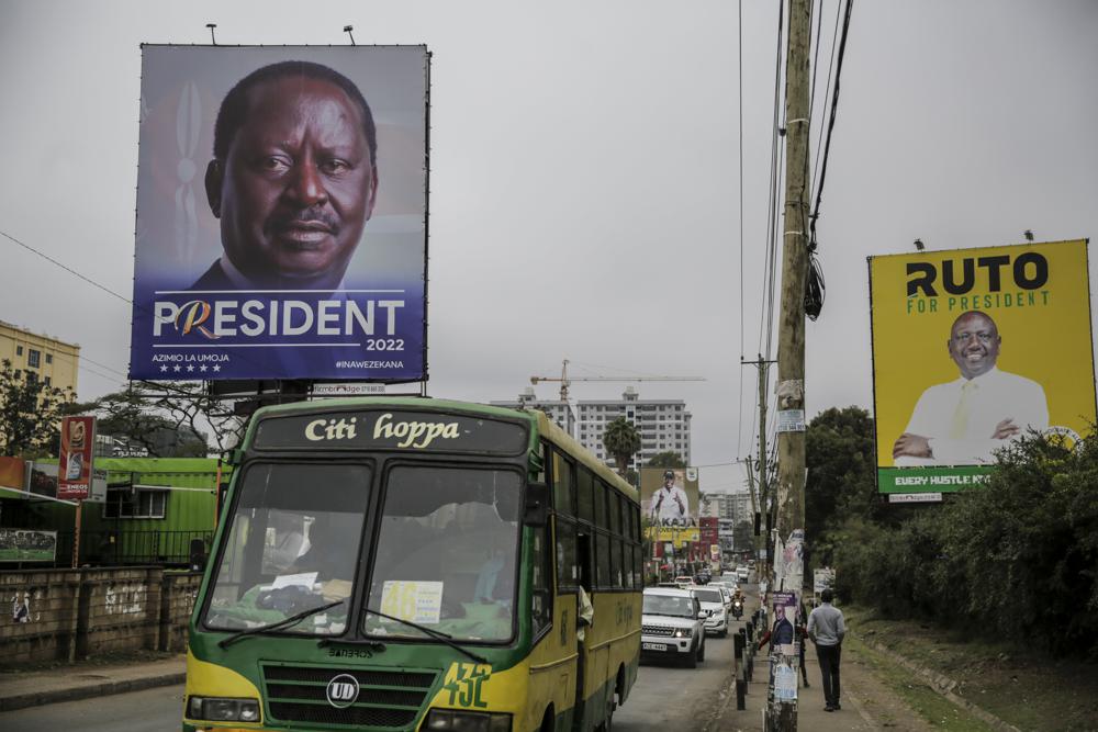 A bus drives past banners for Kenyan presidential candidates Raila Odinga, left, and William Ruto, right, on a road in the Mathare low-income neighborhood of Nairobi, Kenya Monday, Aug. 1, 2022. Kenya’s Aug. 9 election is ripping open the scars of inequality and corruption as East Africa’s economic hub chooses a successor to President Uhuru Kenyatta. (AP Photo/Brian Inganga)