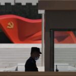 FILE – A security guard stands near a sculpture of the Chinese Communist Party flag at the Museum of the Communist Party of China on May 26, 2022, in Beijing. China said it was conducting military exercises Saturday, July 30, off its coast opposite Taiwan after warning Speaker Nancy Pelosi of the U.S. House of Representatives to scrap possible plans to visit the island democracy, which Beijing claims as part of its territory. (AP Photo/Ng Han Guan, File)