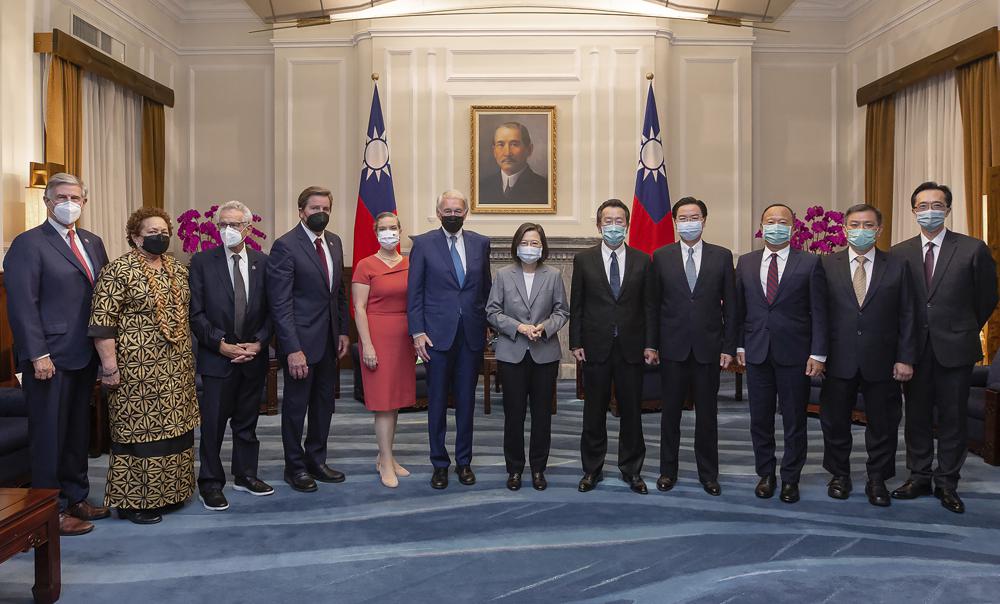 In this photo released by the Taiwan Presidential Office, Taiwan’s President Tsai Ing-wen pose for photos with U.S. Congress members and other Taiwan officials during a meeting at the Presidential Office in Taipei, Taiwan on Monday, Aug. 15, 2022. The delegation of U.S. Congress members visited Taiwan parliament on Monday in a further sign of support among American lawmakers for the self-governing island. (Taiwan Presidential Office via AP)