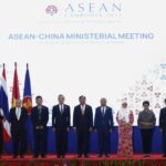 In this photo released by the Agence Kampuchea Press (AKP), Chinese Foreign Minister Wang Yi, fifth from left, poses for a group photo with ASEAN Foreign Ministers during the ASEAN Foreign Ministers Meeting in Phnom Penh, Cambodia, Thursday, Aug. 4, 2022. (AKP via AP)