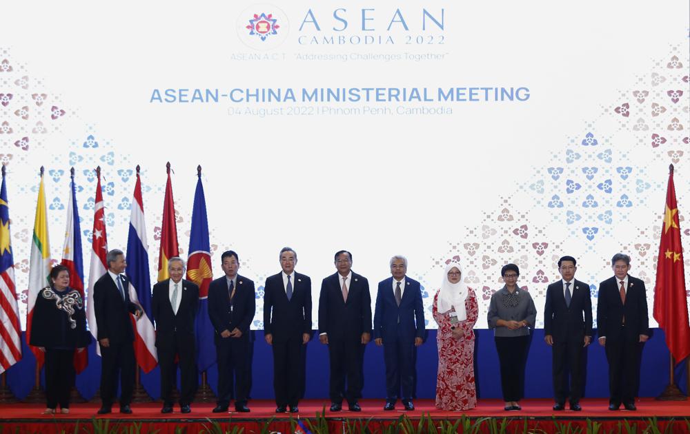 In this photo released by the Agence Kampuchea Press (AKP), Chinese Foreign Minister Wang Yi, fifth from left, poses for a group photo with ASEAN Foreign Ministers during the ASEAN Foreign Ministers Meeting in Phnom Penh, Cambodia, Thursday, Aug. 4, 2022. (AKP via AP)
