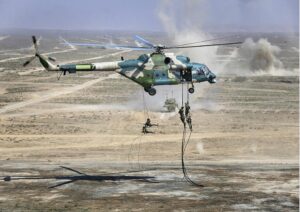 FILE – In this handout photo released by Russian Defense Ministry Press Service, Troops disembark from a Chinese military helicopter during joint war games held by Russia and China held in the Ningxia Hui Autonomous Region in northwestern China on Friday, Aug. 13, 2021. Russia said Monday it will launch sweeping war games drills in the country’s east that will involve forces from China — a show of increasingly close military ties between Moscow and Beijing amid tensions with the West over the Kremlin’s action in Ukraine. (Savitskiy Vadim/Russian Defense Ministry Press Service via AP, File)