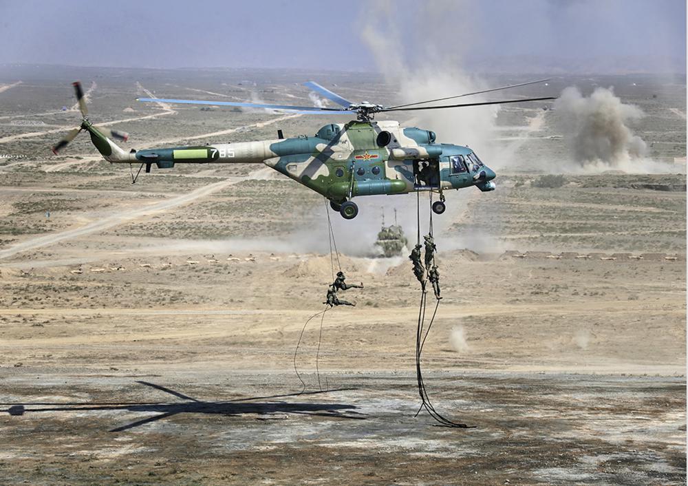 FILE – In this handout photo released by Russian Defense Ministry Press Service, Troops disembark from a Chinese military helicopter during joint war games held by Russia and China held in the Ningxia Hui Autonomous Region in northwestern China on Friday, Aug. 13, 2021. Russia said Monday it will launch sweeping war games drills in the country’s east that will involve forces from China — a show of increasingly close military ties between Moscow and Beijing amid tensions with the West over the Kremlin’s action in Ukraine. (Savitskiy Vadim/Russian Defense Ministry Press Service via AP, File)