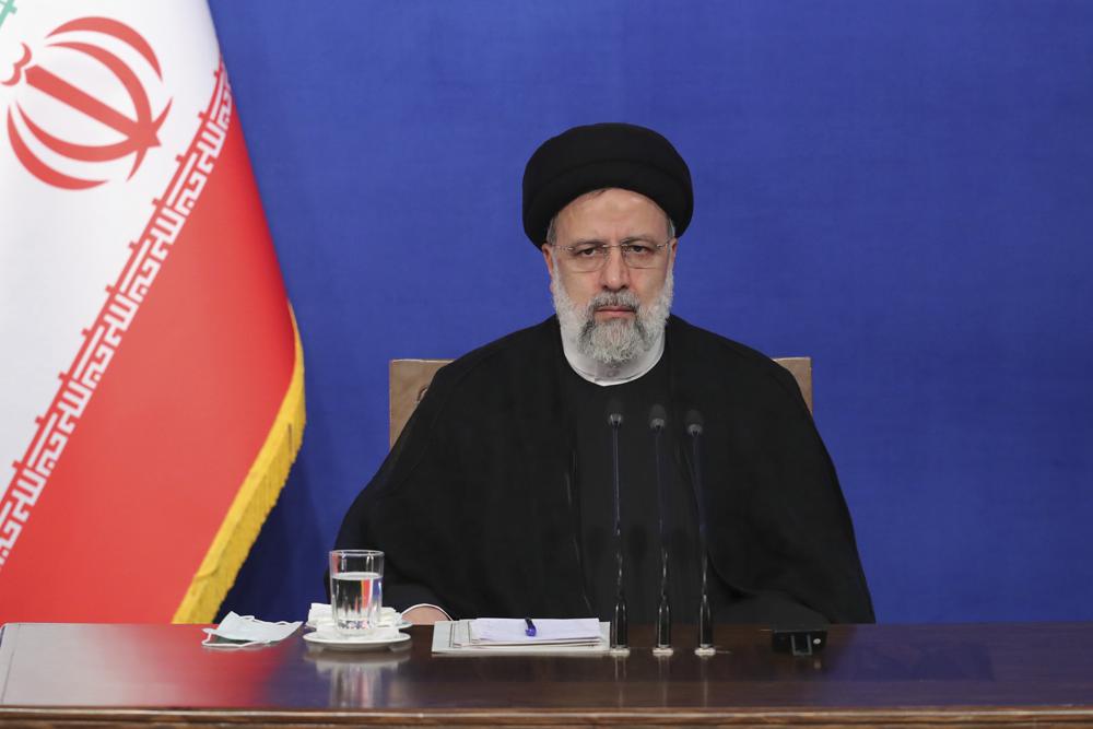 In this photo released by the official website of the office of the Iranian Presidency, President Ebrahim Raisi sits during his press conference in Tehran, Iran, Monday, Aug. 29, 2022. Raisi warned that any roadmap to restore Tehran’s tattered nuclear deal with world powers must see international inspectors end their probe on man-made uranium particles found at undeclared sites in the country. (Iranian Presidency Office via AP)