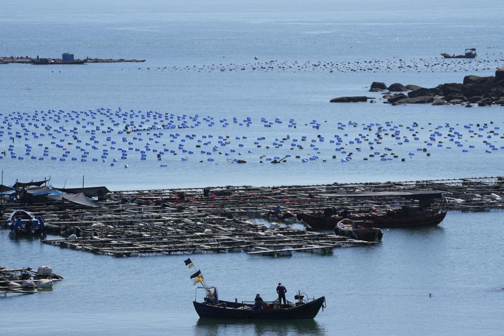 A boat moves through the water at the 68-nautical-mile scenic spot, the closest point in mainland China to the island of Taiwan, in Pingtan in southeastern China’s Fujian Province, Friday, Aug. 5, 2022. China conducted “precision missile strikes” Thursday in waters off Taiwan’s coasts as part of military exercises that have raised tensions in the region to their highest level in decades following a visit by U.S. House Speaker Nancy Pelosi. (AP Photo/Ng Han Guan)