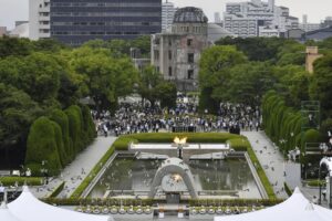 Doves fly over the cenotaph dedicated to the victims of the atomic bombing during the ceremony marking the 77th anniversary of the world’s first atomic bombing, at the Hiroshima Peace Memorial Park in Hiroshima, western Japan Saturday, Aug. 6, 2022. (Kyodo News via AP)