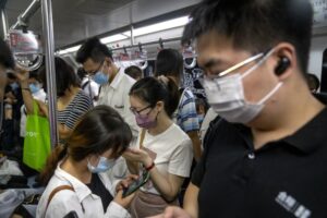Commuters ride on a subway train during the morning rush hour in the central business district in Beijing, Tuesday, Aug. 9, 2022. China’s 11 million university graduates are struggling in a bleak job market this summer as repeated shutdowns under China’s anti-COVID lockdowns forced companies to retrench and driven many restaurants and other small employers out of business. (AP Photo/Mark Schiefelbein)