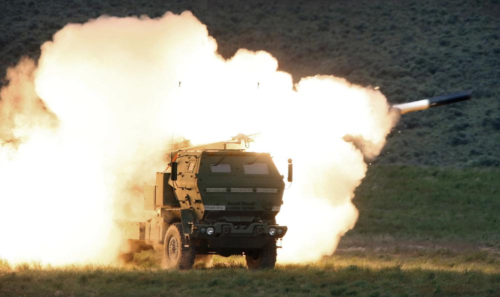 FILE – A launch truck fires the High Mobility Artillery Rocket System (HIMARS) produced by Lockheed Martin during combat training in the high desert of the Yakima Training Center, Washington on May 23, 2011. Ukraine has received about a dozen American-built HIMARS multiple rocket launchers and has used them to strike Russian ammunition depots, which are essential for maintaining Moscow’s edge in firepower. (Tony Overman/The Olympian via AP, File)
