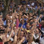 Supporters of Brazil’s former President Luiz Inacio Lula da Silva, who is running for reelection, cheer during a campaign rally outside the Volkswagen automaker´s plant in Sao Bernardo do Campo, greater Sao Paulo area, Brazil, Tuesday, Aug. 16, 2022. Brazil’s general elections are scheduled for Oct. 2, 2022. (AP Photo/Andre Penner)