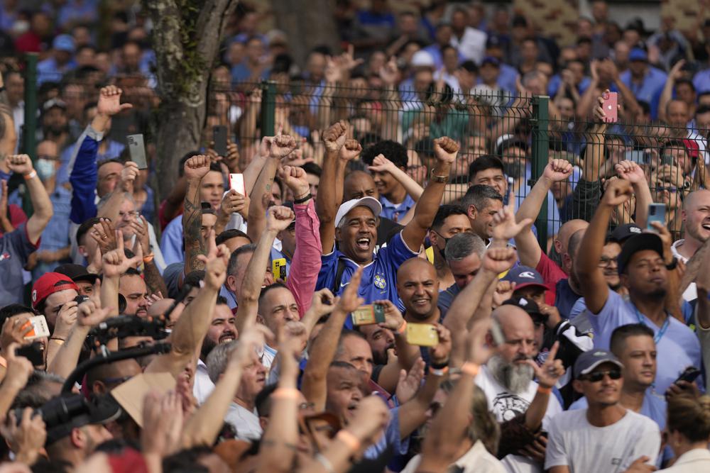 Supporters of Brazil’s former President Luiz Inacio Lula da Silva, who is running for reelection, cheer during a campaign rally outside the Volkswagen automaker´s plant in Sao Bernardo do Campo, greater Sao Paulo area, Brazil, Tuesday, Aug. 16, 2022. Brazil’s general elections are scheduled for Oct. 2, 2022. (AP Photo/Andre Penner)