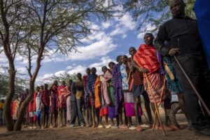 Maasai wait in line to cast their votes in the general election at a polling station in Esonorua Primary School, in Kajiado County, Kenya Tuesday, Aug. 9, 2022. Polls opened Tuesday in Kenya’s unusual presidential election, where a longtime opposition leader who is backed by the outgoing president faces the deputy president who styles himself as the outsider. (AP Photo/Ben Curtis)