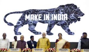 FILE – Indian Prime Minister Narendra Modi, center, unveils the logo of ‘Make in India’ initiative in New Delhi, India, Sept. 25, 2014. India’s phenomenal transformation from an impoverished nation in 1947 into an emerging global power whose $3 trillion economy is Asia’s third largest has made it a major exporter of things like software and vaccines. The country marks 75 years of independence from British rule on Aug. 15. (AP Photo/Saurabh Das, File)