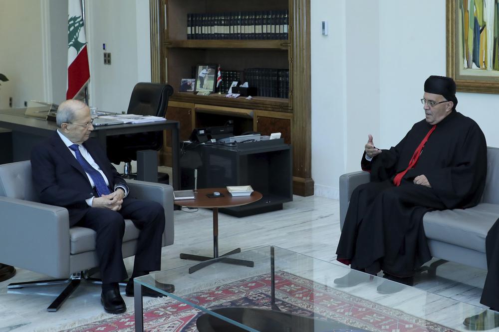 In this photo released by Lebanon’s official government photographer Dalati Nohra, Lebanese president Michel Aoun meets with Lebanese Maronite archbishop Moussa el-Hajj, at the presidential palace, in Baabda east of Beirut, Lebanon, July 22, 2022. The brief detention of el-Hajj who was caught with more than $450,000 in cash as he crossed from Israel to Lebanon is further stoking sectarian tensions in his crisis-hit homeland. (Dalati Nohra via AP)