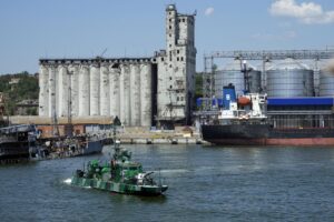 FILE – A Russian military boat guards an area with the grain storage in the background at the Mariupol Sea Port which has recently started its work after heavy fighting in Mariupol, on the territory which is under the Government of the Donetsk People’s Republic control, eastern Ukraine, June 12, 2022. Ukraine is steadily exporting grains from its Black Sea ports under a wartime deal brokered last month, but the agreement has also proven helpful to Russian farmers and the country’s cornerstone agriculture industry. This photo was taken during a trip organized by the Russian Ministry of Defense. (AP Photo, File)