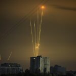 Russian rockets launch against Ukraine from Russia’s Belgorod region are seen at dawn in Kharkiv, Ukraine, early Saturday, Aug. 20, 2022. (AP Photo/Vadim Belikov)