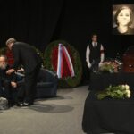 Philosopher Alexander Dugin, left, attends the final farewell ceremony for his daughter Daria Dugina in Moscow, Russia, Tuesday, Aug. 23, 2022. Daria Dugina, a 29-year-old commentator with a nationalist Russian TV channel, died when a remotely controlled explosive device planted in her SUV blew up on Saturday night as she was driving on the outskirts of Moscow, ripping the vehicle apart and killing her on the spot, authorities said. (AP Photo/Dmitry Serebryakov)