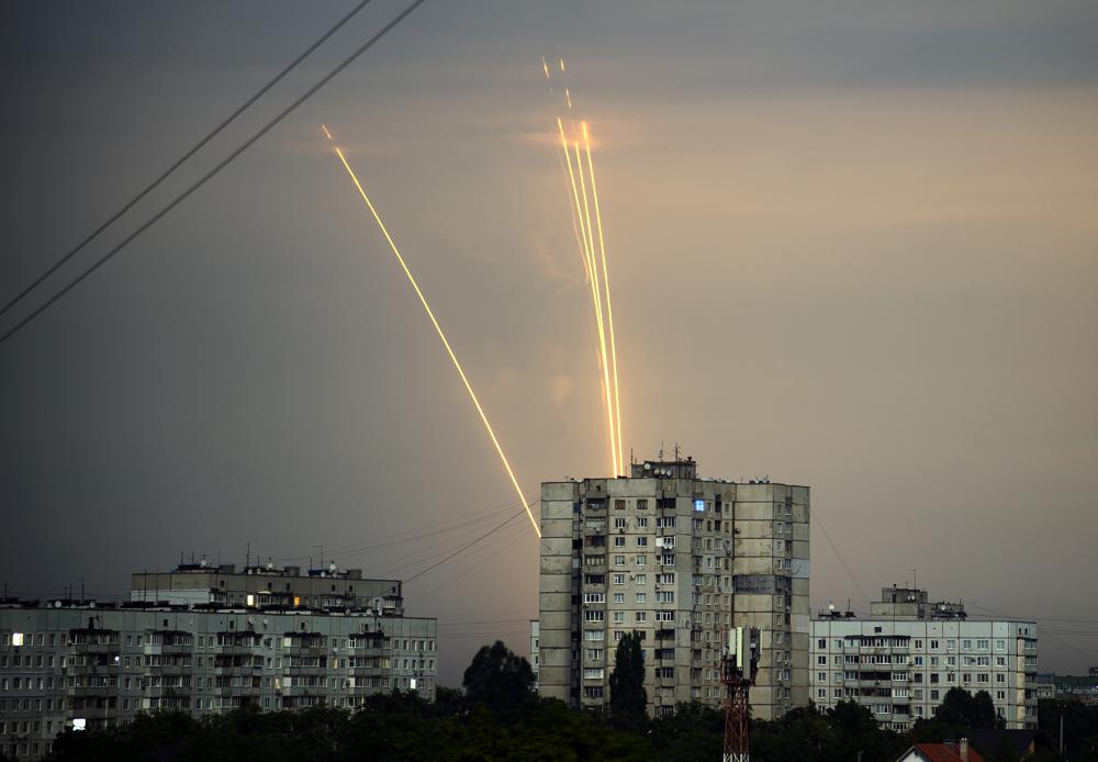 Russian rockets launch against Ukraine from Russia’s Belgorod region are seen at dawn in Kharkiv, Ukraine, Monday, Aug. 15, 2022. (AP Photo/Vadim Belikov)