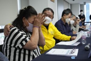 Park Sun-yi, left, a victim of Brothers Home, weeps during a press conference at the Truth and Reconciliation Commission office in Seoul, South Korea, Wednesday, Aug. 24, 2022. The commission has found the country’s past military governments responsible for atrocities committed at Brothers Home, a state-funded vagrants’ facility where thousands were enslaved and abused from the 1960s to 1980s. (AP Photo/Ahn Young-joon)