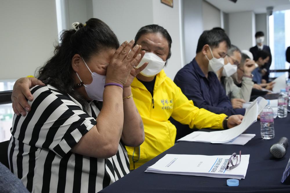 Park Sun-yi, left, a victim of Brothers Home, weeps during a press conference at the Truth and Reconciliation Commission office in Seoul, South Korea, Wednesday, Aug. 24, 2022. The commission has found the country’s past military governments responsible for atrocities committed at Brothers Home, a state-funded vagrants’ facility where thousands were enslaved and abused from the 1960s to 1980s. (AP Photo/Ahn Young-joon)