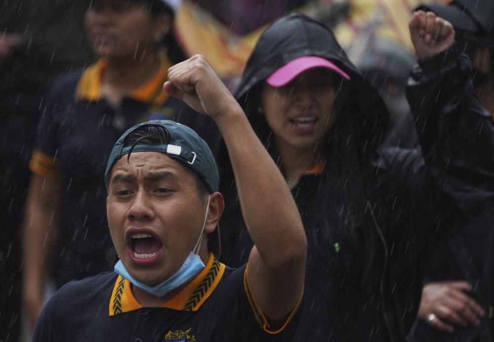 A demonstrator takes part in a march seeking justice for the missing 43 Ayotzinapa students in Mexico City, Friday, Aug. 26, 2022. Six of the 43 college students “disappeared” in 2014 were allegedly kept alive in a warehouse for days then turned over to the local army commander who ordered them killed, the Mexican government official