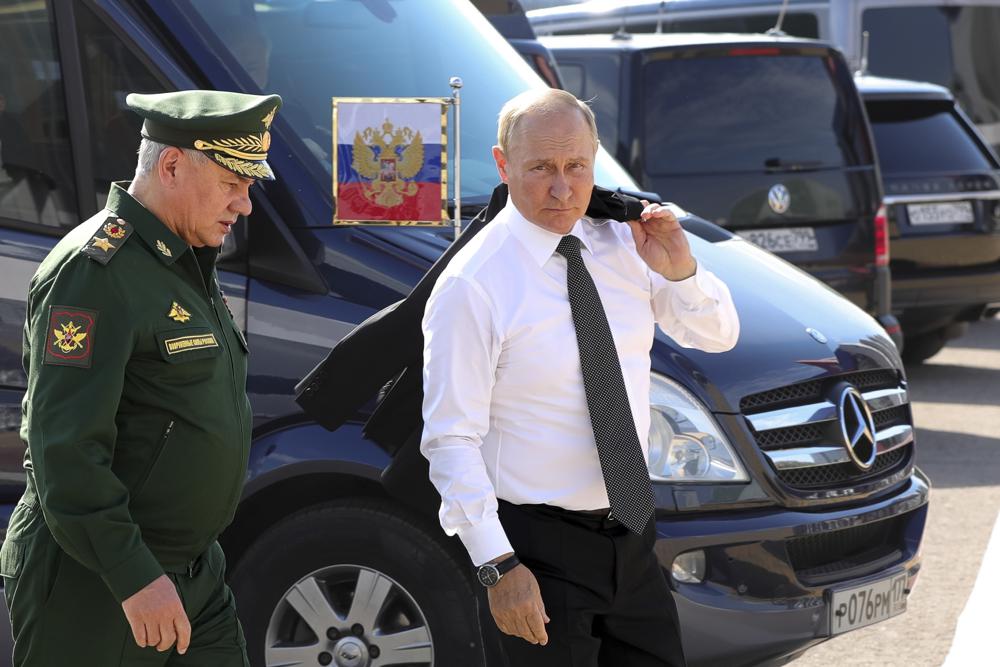 Russia’s President Vladimir Putin and Russian Defense Minister Sergei Shoigu arrive to attend the opening of the Army 2022 International Military and Technical Forum in the Patriot Park outside Moscow, Russia, Monday, Aug. 15, 2022. Putin vowed to strengthen Russia’s military cooperation with its allies. (Mikhail Klimentyev, Sputnik, Kremlin Pool Photo via AP)