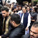 Former Pakistani Prime Minister Imran Khan, center, leaves an anti-terrorism court in Islamabad, Pakistan, Thursday, Aug. 25, 2022. The court on Thursday extended former premier Imran Khan’s protection from arrest through the end of the month, officials said, after police filed terrorism charges against the country’s popular opposition leader. (AP Photo/W.K. Yousafzai)