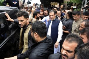 Former Pakistani Prime Minister Imran Khan, center, leaves an anti-terrorism court in Islamabad, Pakistan, Thursday, Aug. 25, 2022. The court on Thursday extended former premier Imran Khan’s protection from arrest through the end of the month, officials said, after police filed terrorism charges against the country’s popular opposition leader. (AP Photo/W.K. Yousafzai)