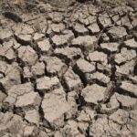 FILE – Cracked dry mud is seen in a community reservoir that ran nearly empty after its retaining wall started to leak and hot weather and drought conditions accelerated the loss of water Longquan village in southwestern China’s Chongqing Municipality, Saturday, Aug. 20, 2022. The very landscape of Chongqing, a megacity that also takes in surrounding farmland and steep and picturesque mountains, has been transformed by an unusually long and intense heat wave and an accompanying drought. (AP Photo/Mark Schiefelbein, File)