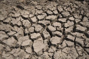 FILE – Cracked dry mud is seen in a community reservoir that ran nearly empty after its retaining wall started to leak and hot weather and drought conditions accelerated the loss of water Longquan village in southwestern China’s Chongqing Municipality, Saturday, Aug. 20, 2022. The very landscape of Chongqing, a megacity that also takes in surrounding farmland and steep and picturesque mountains, has been transformed by an unusually long and intense heat wave and an accompanying drought. (AP Photo/Mark Schiefelbein, File)