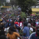 Demonstrators fill the streets during a protest in Port-au-Prince, Haiti, Monday, Aug. 22, 2022. Protesters marched through Haiti’s capital and other major cities, blocking roads and shutting down businesses to demand that Prime Minister Ariel Henry step down and call for a better quality of life. (AP Photo/Odelyn Joseph)