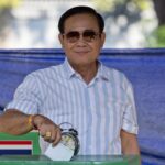FILE – Thailand’s Prime Minister Prayuth Chan-ocha casts his vote at a polling station in Bangkok, Thailand, Sunday, March 24, 2019, during the nation’s first general election since the military seized power in a 2014 coup. Thailand’s Constitutional Court suspended Prayuth from his duties on Wednesday, Aug. 25, 2022, while it decides whether he violated the country’s term limits, potentially opening a new chapter of turmoil in the nation’s troubled politics. (AP Photo/Gemunu Amarasinghe, File)