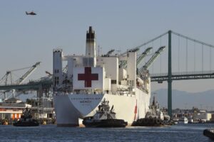 FILE – The USNS Mercy hospital ship enters the Port of Los Angeles, March 27, 2020. The Solomon Islands government on Wednesday, Aug. 31, 2022, asked countries to not send naval vessels to the South Pacific nation until approval processes are overhauled. The U.S. Navy hospital ship USNS Mercy is currently in Honiara. (AP Photo/Mark J. Terrill, File)