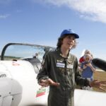 Seventeen year old Anglo-Belgian pilot, Mack Rutherford, speaks with the media after landing at the Buzet airfield in Pont-A-Celles, Belgium, Tuesday, Aug. 23, 2022. Rutherford landed in Belgium before flying on to Slovakia and Sofia, Bulgaria, for the final leg of his Guinness World Record attempt to be the youngest person to the fly around the world solo in a small plane. (AP Photo/Virginia Mayo)
