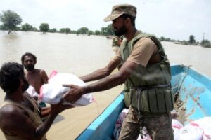 Soldiers distribute food to flood-affected people in Punjab province