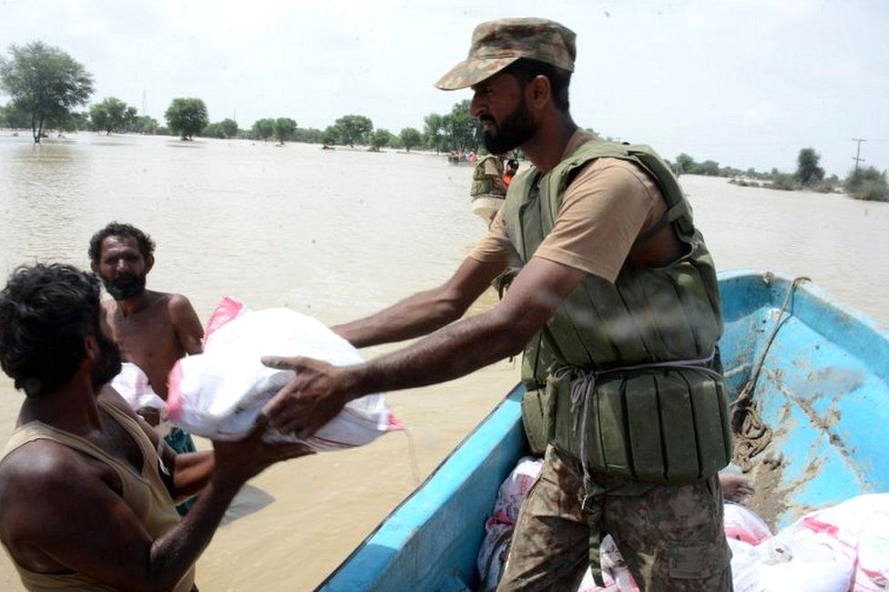 Soldiers distribute food to flood-affected people in Punjab province