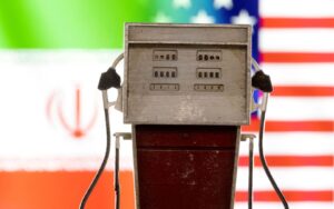 Model of petrol pump is seen in front of U.S. and Iran flag colors in this illustration taken March 25, 2022. REUTERS/Dado Ruvic/Illustration