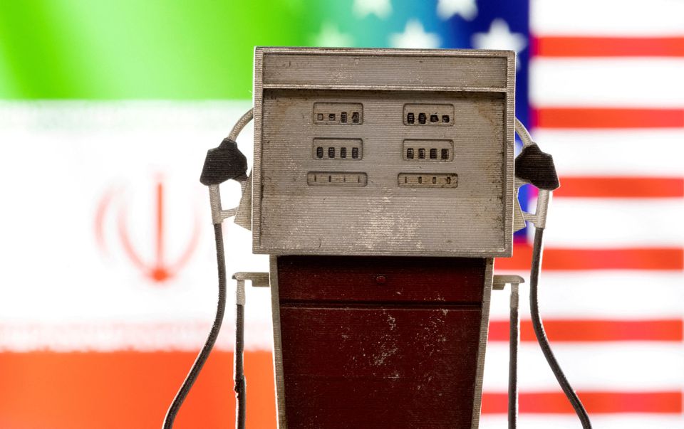 Model of petrol pump is seen in front of U.S. and Iran flag colors in this illustration taken March 25, 2022. REUTERS/Dado Ruvic/Illustration