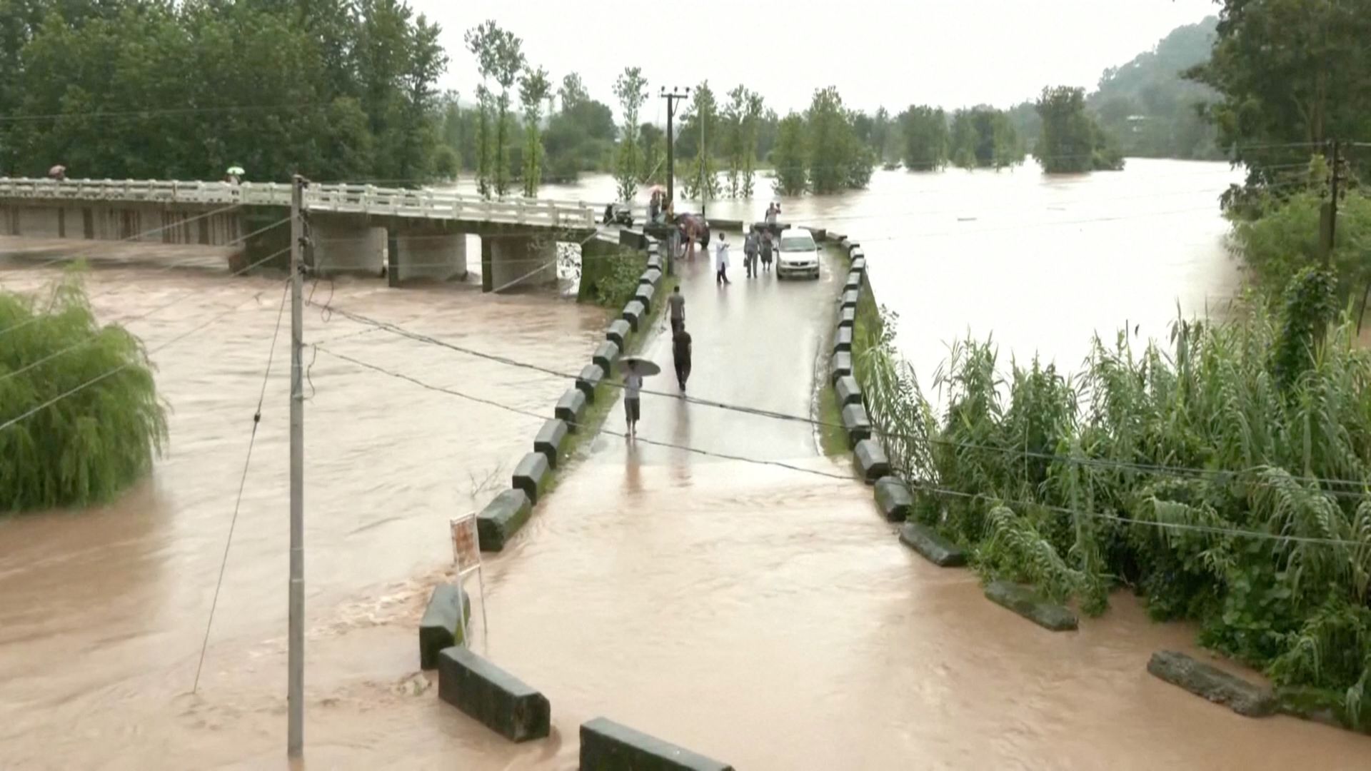 A general view of a flooded bridge following heavy rains in Mandi, Himachal Pradesh, India August 20, 2022 in this screen grab obtained from a video. ANI via REUTERS