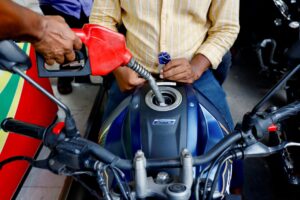 People refuel their motorcycles at a gasoline station after fuel price surge up to fifty percent in Dhaka, Bangladesh, August 6, 2022. REUTERS/Mohammad Ponir Hossain