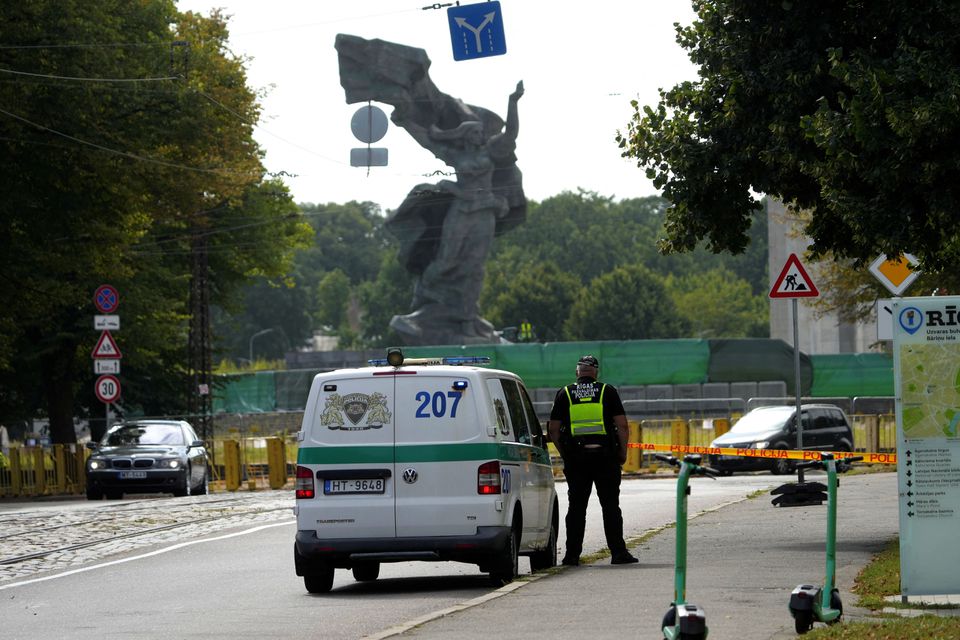 A municipal police officer looks on during dismantling of a Soviet World War Two victory monument in Riga, Latvia August 23, 2022. REUTERS/Ints Kalnins