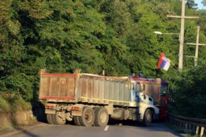 A Serbian flag is seen as trucks block a road in Zupce, Kosovo August 1, 2022. REUTERS/Fatos Bytyci/File Photo