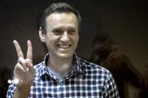 FILE — Russian opposition leader Alexei Navalny gestures as he stands behind a glass panel of a cage in the Babuskinsky District Court in Moscow, Russia, Saturday, Feb. 20, 2021. On the second anniversary of the poison attack on Alexei Navalny, Germany and the United States have recalled the fate of Kremlin critic Alexei Navalny who is imprisoned in Russia. German Chancellor Olaf Scholz praised the Russian opposition politician’s courage in a video message Saturday. (AP Photo/Alexander Zemlianichenko,file)