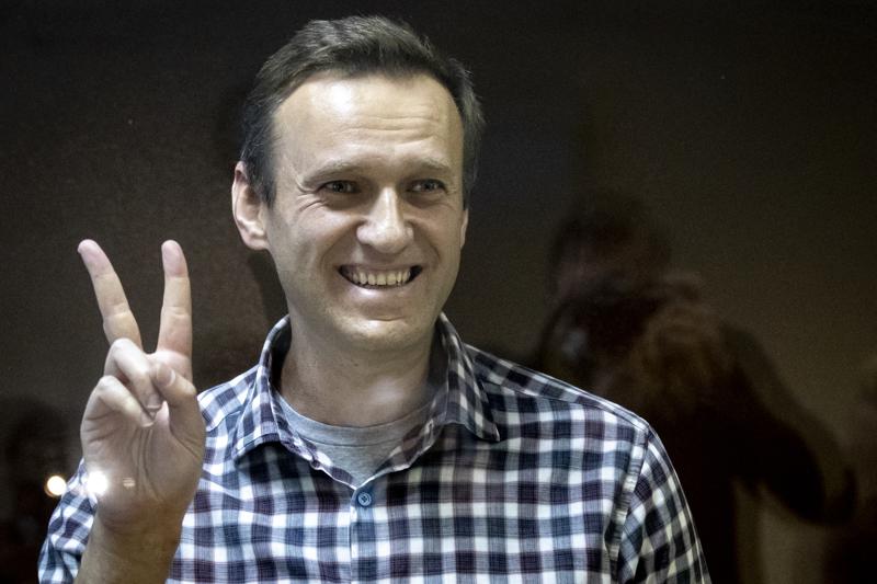 FILE — Russian opposition leader Alexei Navalny gestures as he stands behind a glass panel of a cage in the Babuskinsky District Court in Moscow, Russia, Saturday, Feb. 20, 2021. On the second anniversary of the poison attack on Alexei Navalny, Germany and the United States have recalled the fate of Kremlin critic Alexei Navalny who is imprisoned in Russia. German Chancellor Olaf Scholz praised the Russian opposition politician’s courage in a video message Saturday. (AP Photo/Alexander Zemlianichenko,file)