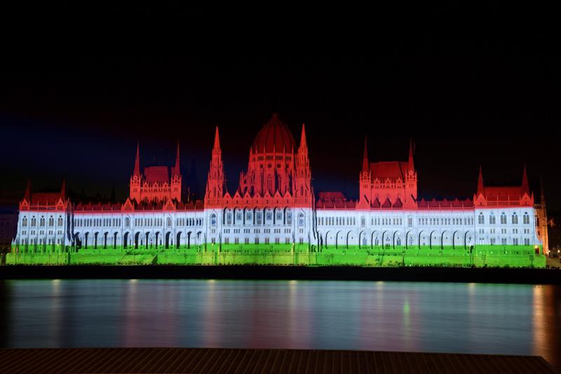 FILE – The colors of the Hungarian flag illuminate the Parliament building to mark the national holiday celebrating Hungary’s statehood in Budapest, Hungary, Saturday, Aug. 20, 2022. State founder St. Stephen I, the first king of Hungary was crowned in 1000 A.D. The two top officials of Hungary’s meteorological service have been fired after an inaccurate rain forecast prompted the postponement of a fireworks display on the country’s most important national holiday. (Peter Lakatos/MTI via AP, File)