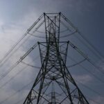 FILE – An electricity pylon is seen in Lydd, southern England, Monday, Aug. 15, 2022. A deepening cost-of-living crisis in Britain is about to worsen, with millions of people expected to pay more a year on their household energy bills starting in October. The U.K. energy regulator on Friday, Aug. 26 is set to announce the latest price cap, which is the maximum amount that gas suppliers can charge customers per unit of energy. It could mean people pay up to 3,600 pounds ($4,240) a year for heating and electricity. (AP Photo/Frank Augstein, file)