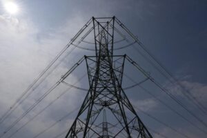 FILE – An electricity pylon is seen in Lydd, southern England, Monday, Aug. 15, 2022. A deepening cost-of-living crisis in Britain is about to worsen, with millions of people expected to pay more a year on their household energy bills starting in October. The U.K. energy regulator on Friday, Aug. 26 is set to announce the latest price cap, which is the maximum amount that gas suppliers can charge customers per unit of energy. It could mean people pay up to 3,600 pounds ($4,240) a year for heating and electricity. (AP Photo/Frank Augstein, file)