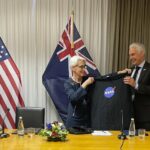 U.S. Deputy Secretary of State Wendy Sherman, left, hands New Zealand Economic and Regional Development Minister Stuart Nash a NASA t-shirt Tuesday, Aug. 9, 2022, during an agreement-signing event in Wellington, New Zealand. The United States is doubling down on its investment in the Pacific, said Sherman on Tuesday as she concluded a five-nation visit to the region. (AP Photo/Nick Perry)
